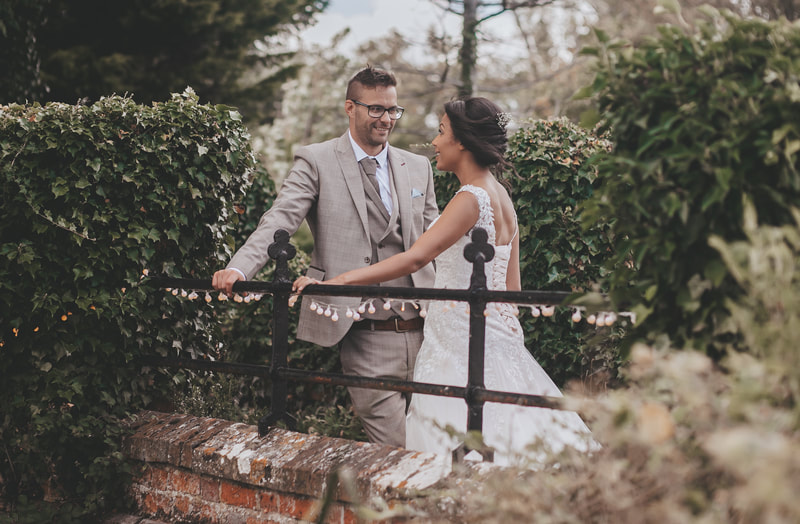 Stunning wedding couple sharing a moments together on a bridge 